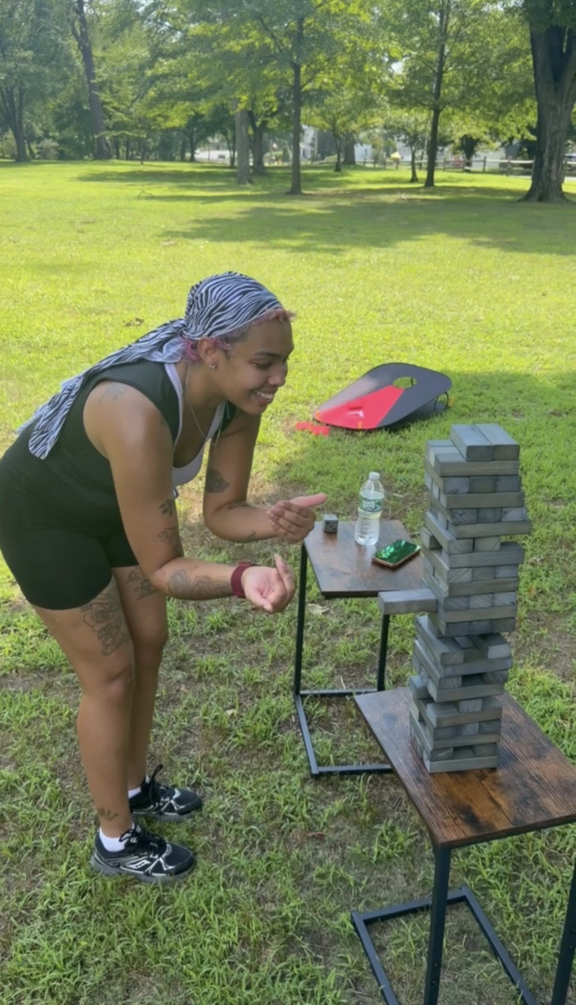 Woman playing Giant Jenga at the Indigo Streets August 8 meetup